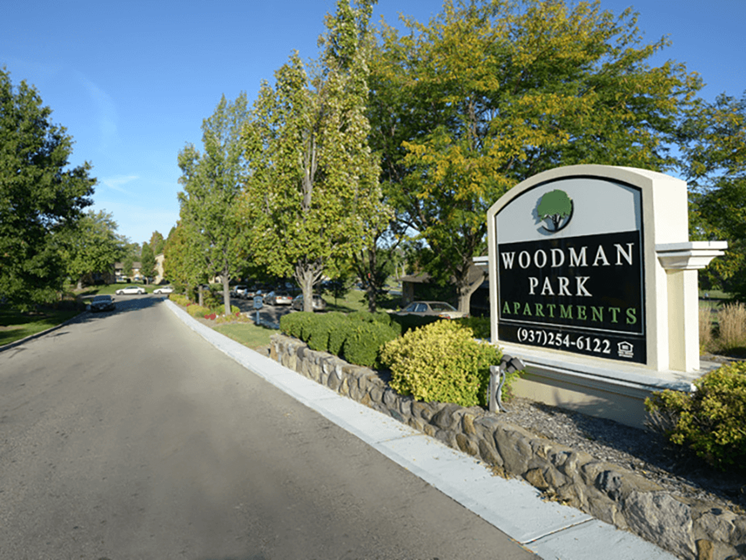 welcome sign at Woodman Park Apartments